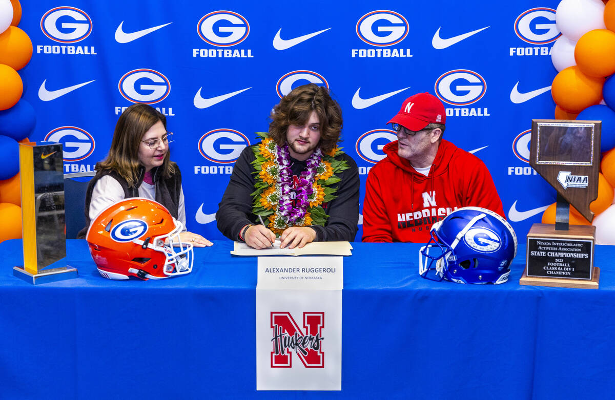 Bishop Gorman player Alexander Ruggeroli and family with a commitment letter to the University ...