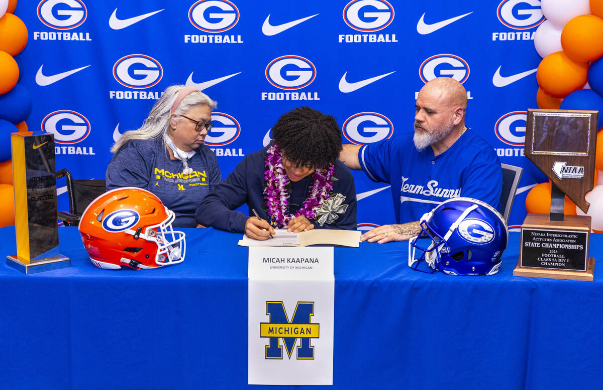 Bishop Gorman player Micah Kaapana and family with a commitment letter to the University of Mic ...