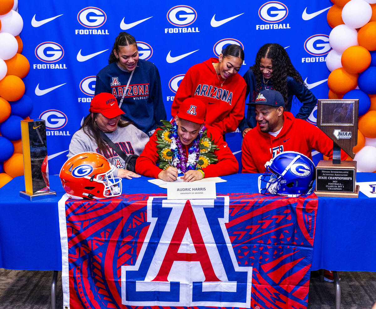 Bishop Gorman player Audric Harris and family with a commitment letter to the University of Ari ...