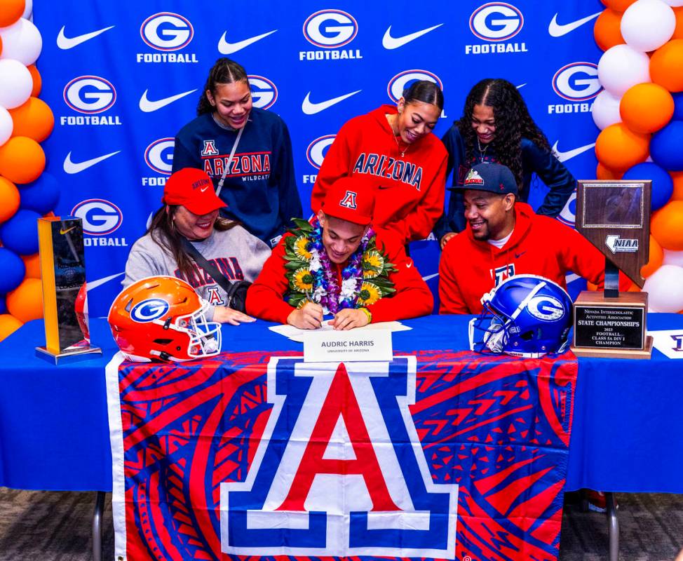 Bishop Gorman player Audric Harris and family with a commitment letter to the University of Ari ...
