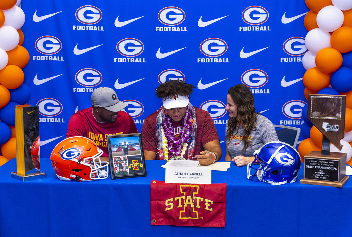Bishop Gorman player Alijah Carnell and family with a commitment letter to the Iowa State Unive ...
