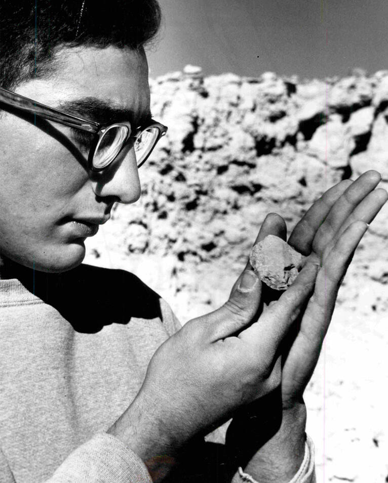 Student archaeologist Mark Levine holds a stone scraper which scientists working on the Tule Sp ...