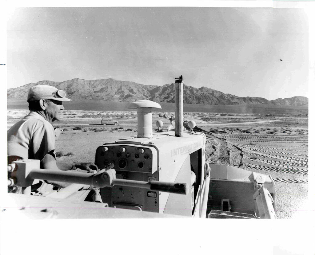 A workman guides a big bulldozer through its paces at Tule Springs on a search for earliest man ...