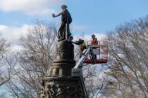 Workers prepare a Confederate Memorial for removal in Arlington National Cemetery on Monday, De ...