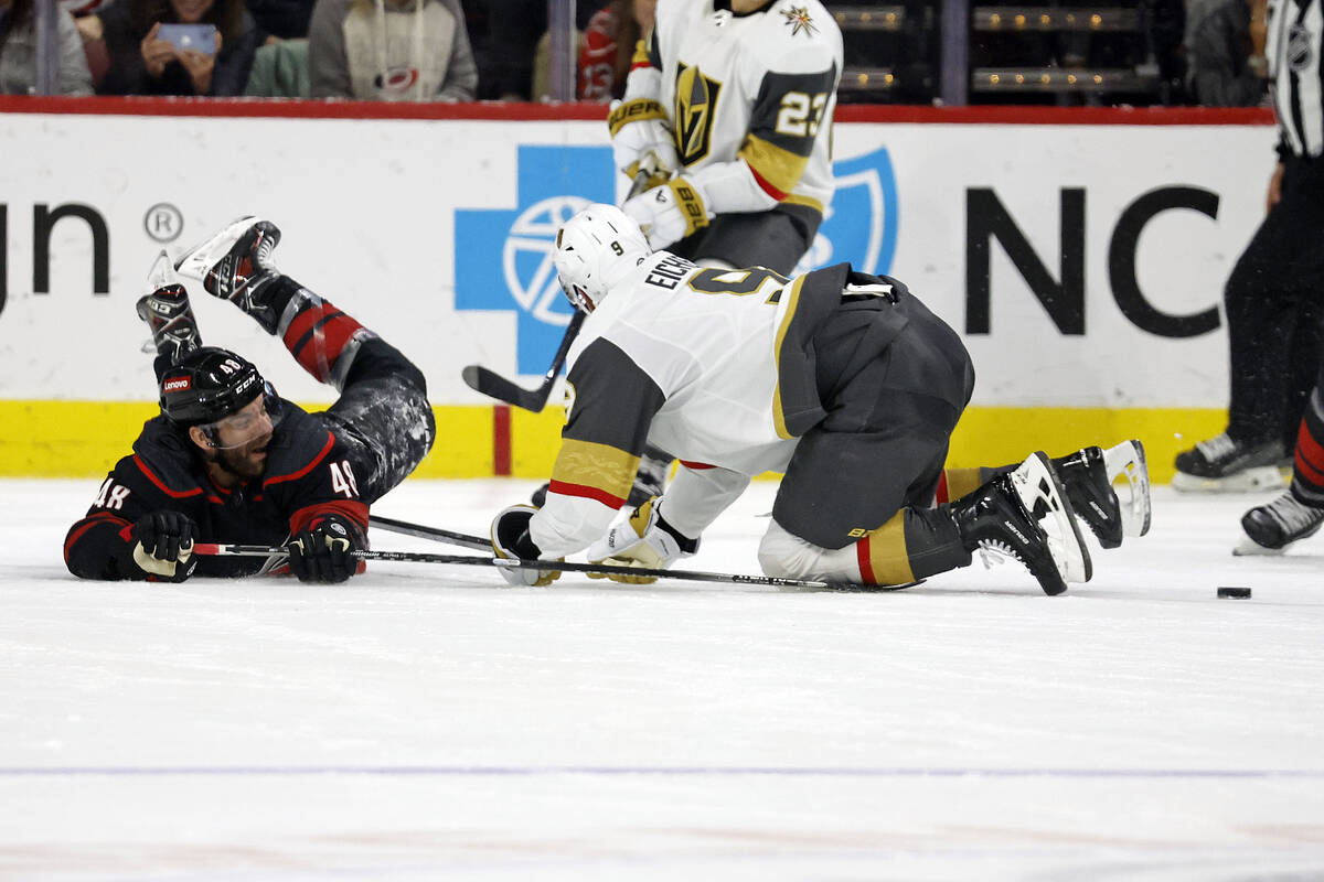 Carolina Hurricanes' Jordan Martinook (48) loses control of the puck when he collides with Vega ...