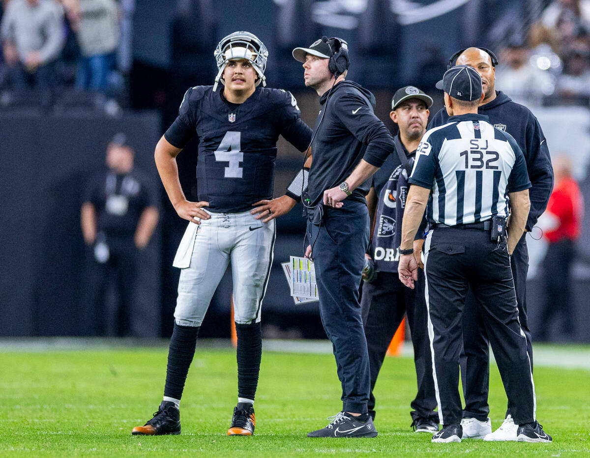 Raiders quarterback Aidan O'Connell (4) stands with Offensive Coordinator Bo Hardegree on the f ...
