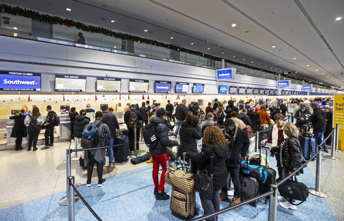 Passengers line up to check-in at Southwest Airlines at Harry Reid International Airport on Thu ...