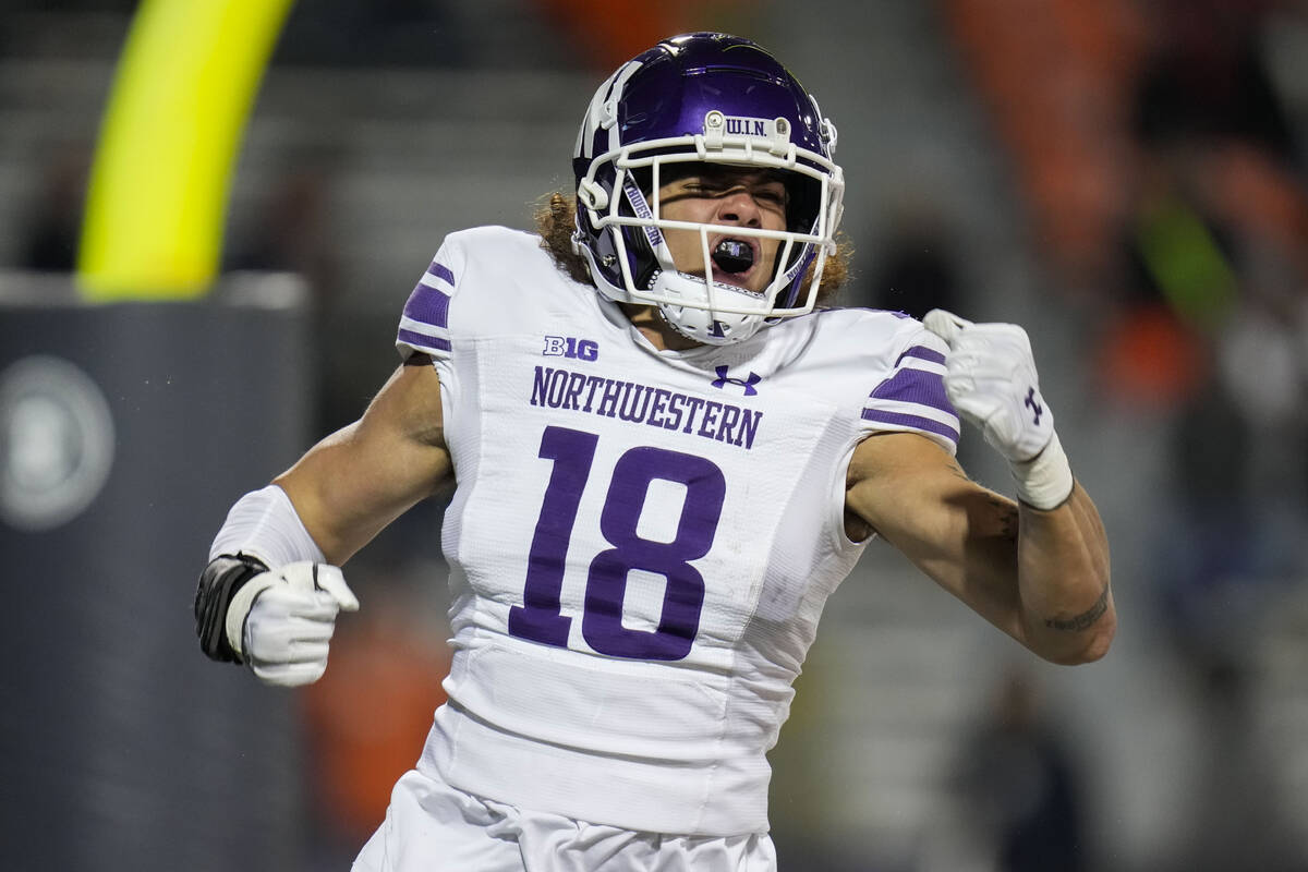 Northwestern defensive back Garner Wallace celebrates after recovering a fumble by Illinois and ...