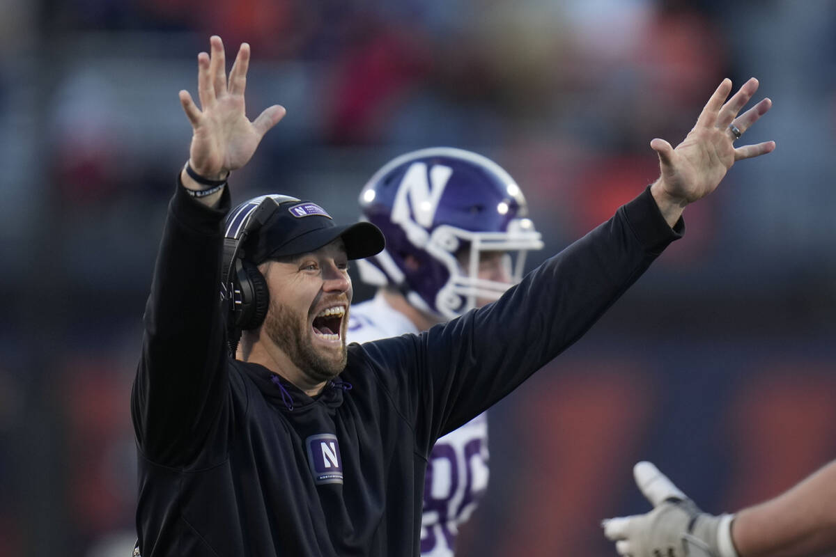 Northwestern head coach David Braun throws up his hands after Illinois offensive lineman Dom D' ...