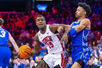 UNLV Rebels guard Luis Rodriguez (15) battles in the lane with Creighton Bluejays guard Trey Al ...