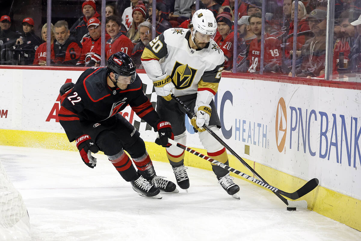 Carolina Hurricanes' Brett Pesce (22) battles for the puck with Vegas Golden Knights' Chandler ...