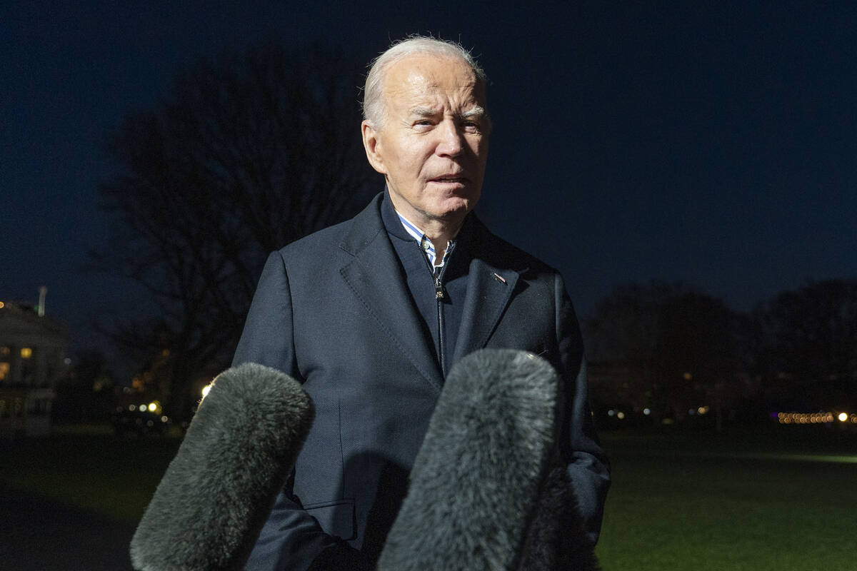 FILE - President Joe Biden answers a reporter's question as he walks from Marine One upon arriv ...