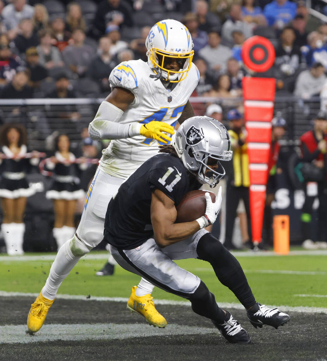 Raiders wide receiver Tre Tucker (11) scores his second touchdown in front of Los Angeles Charg ...