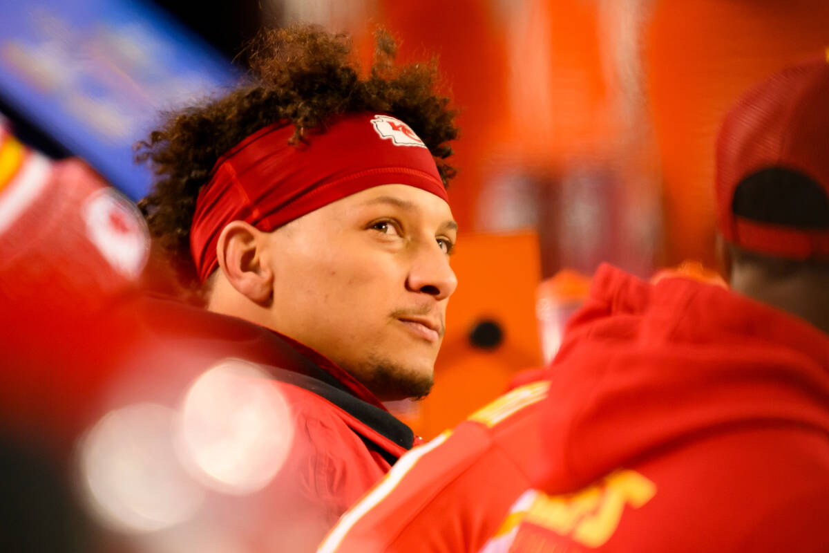 Kansas City Chiefs quarterback Patrick Mahomes looks to the scoreboard from the bench during th ...