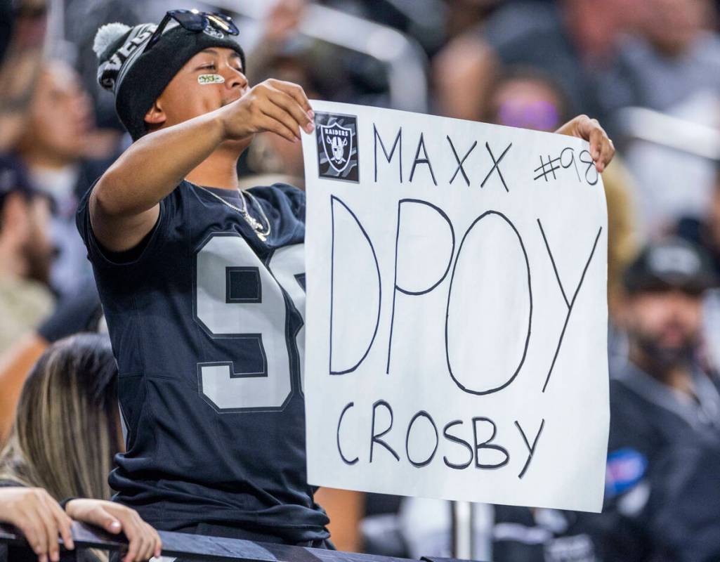A Raiders fan holds a sign for defensive end Maxx Crosby (98) against the New York Jets during ...