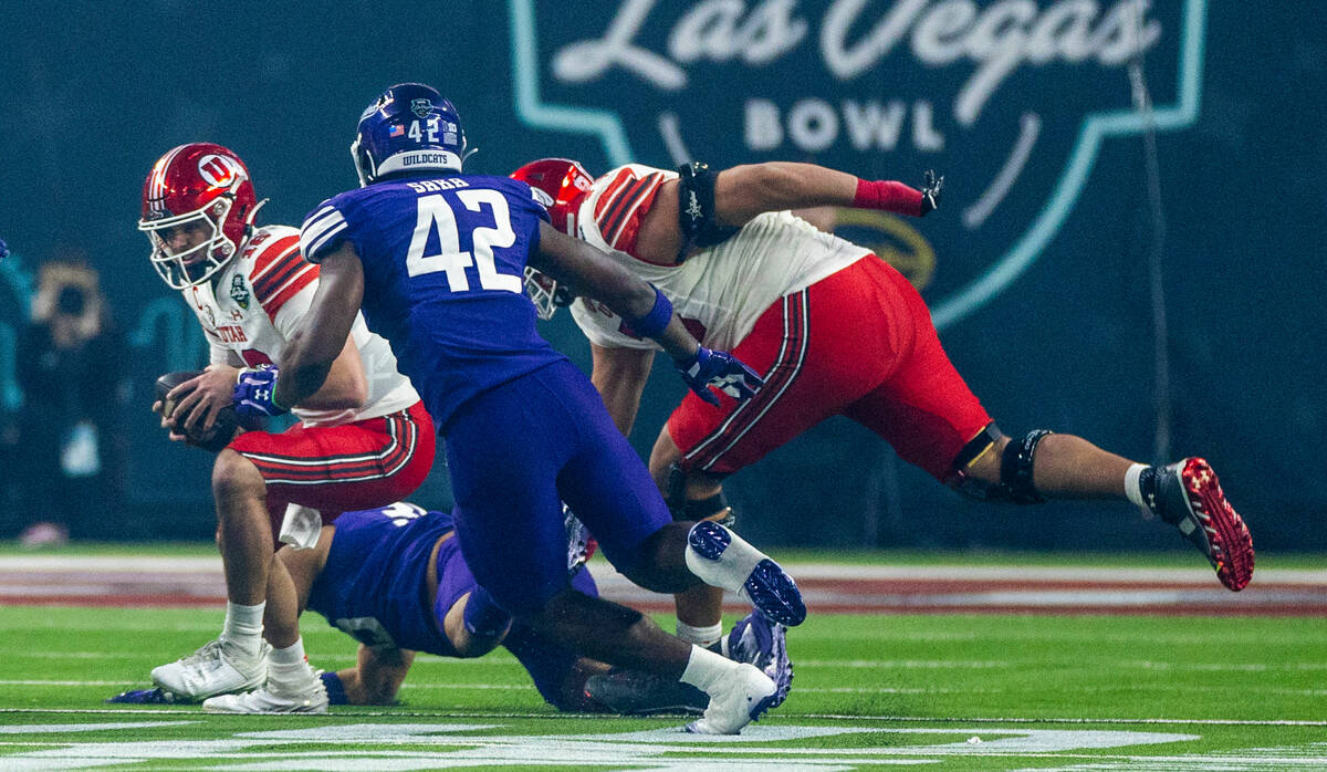 Utah Utes quarterback Bryson Barnes (16) is sacked by the Northwestern Wildcats defense during ...
