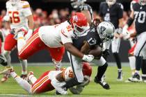 Raiders wide receiver Davante Adams (17) is takedown by Kansas City Chiefs defensive tackle Der ...