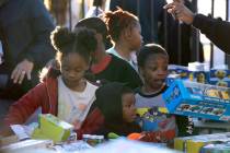 Kids looks for a free toy during a Christmas block party organized by Take Back the Block and M ...