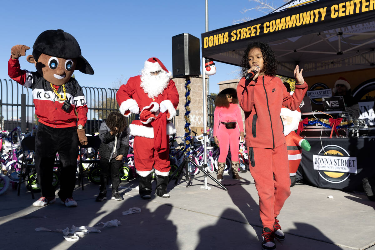 Local rapper Lil Jeezy, 10, spits bars during a Christmas block party organized by Take Back th ...