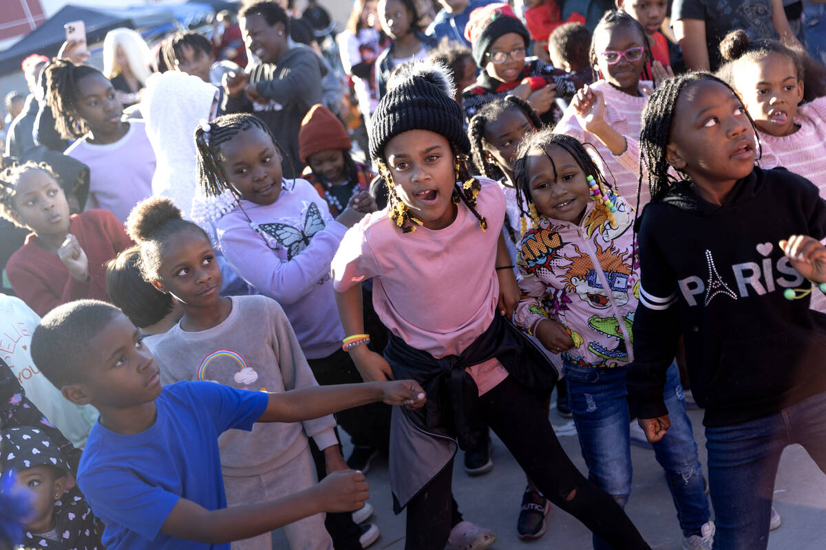 Kids, including winner Khloe West, 9, center, participate in a dance contest during a Christmas ...