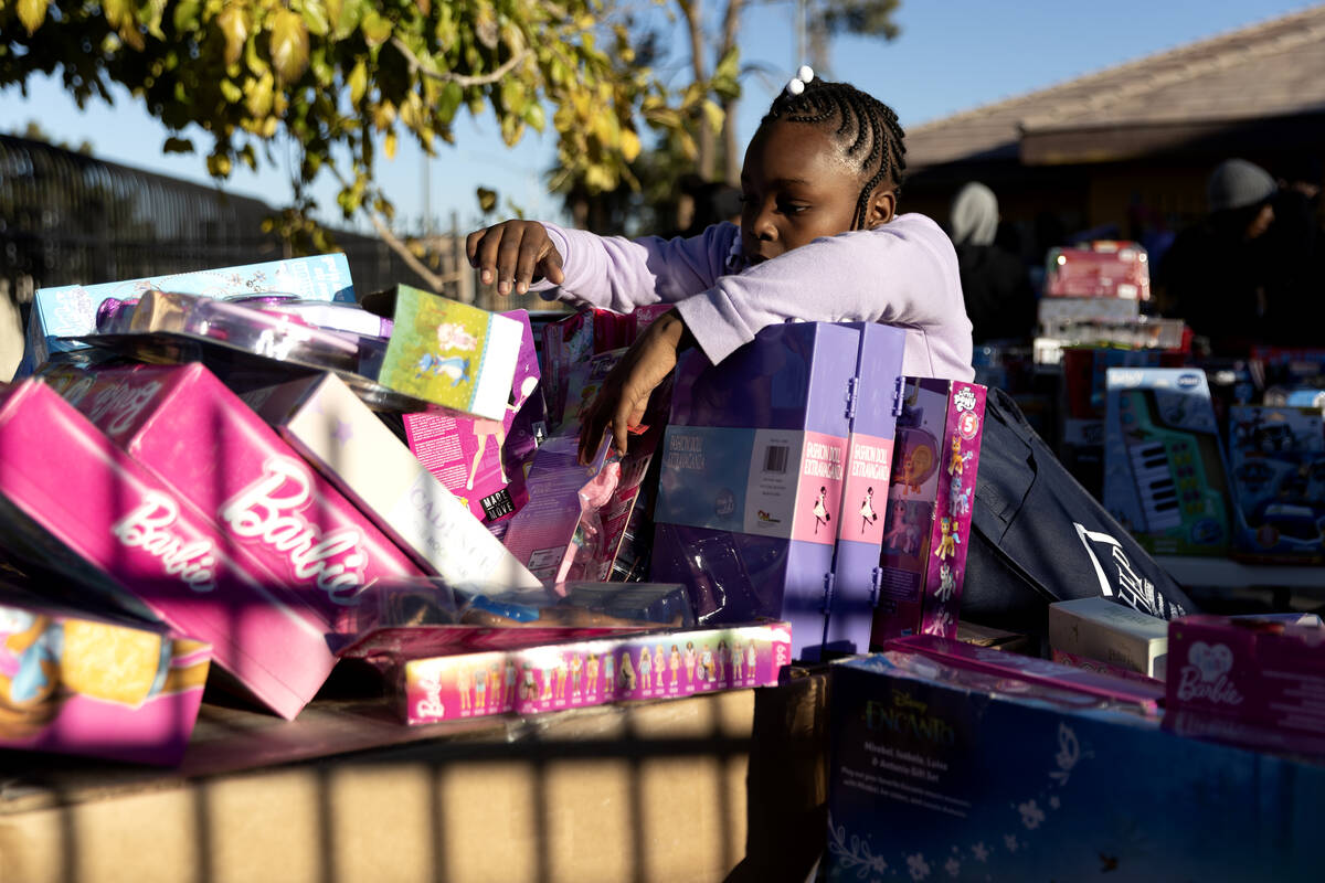 Free toys are available to neighborhood children during a Christmas block party organized by Ta ...