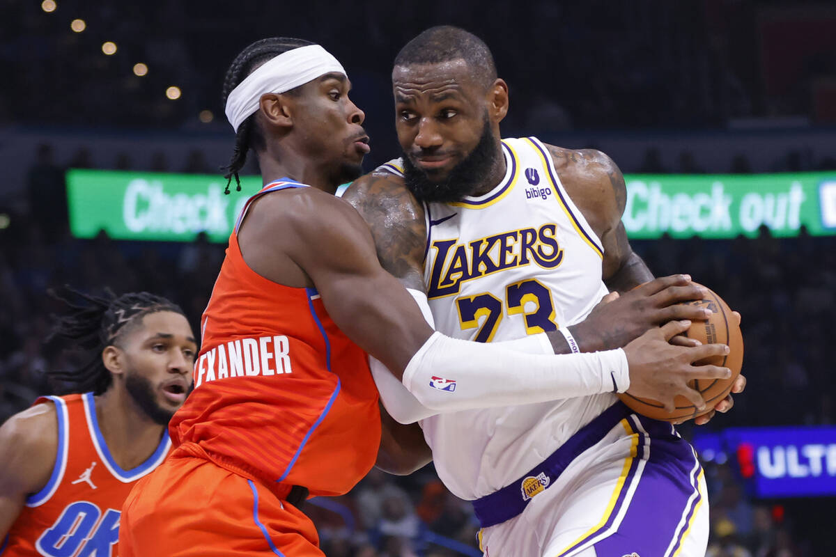 Los Angeles Lakers forward LeBron James, right, drives as Oklahoma City Thunder guard Shai Gilg ...
