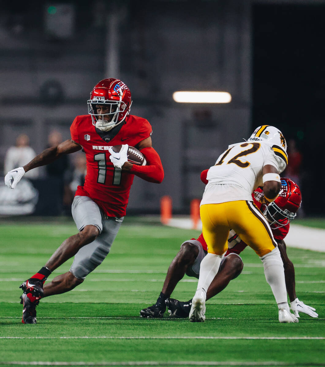 UNLV wide receiver Ricky White runs the ball during a game against Wyoming at Allegiant Stadium ...