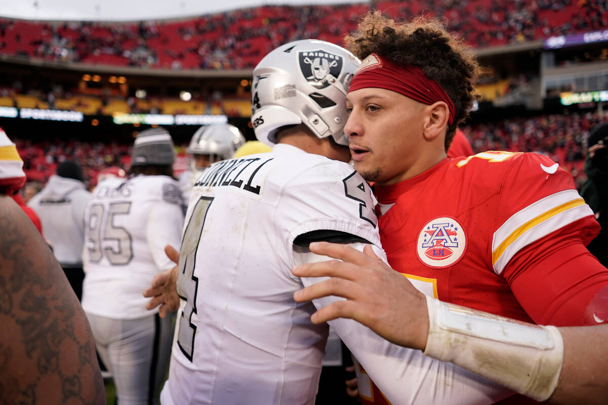 Kansas City Chiefs quarterback Patrick Mahomes, right, hugs Las Vegas Raiders quarterback Aidan ...