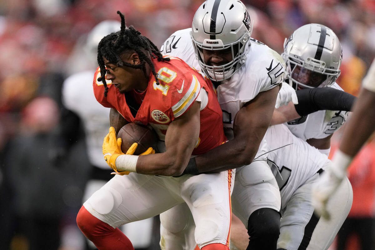 Kansas City Chiefs running back Isiah Pacheco (10) is stopped by Las Vegas Raiders linebacker D ...