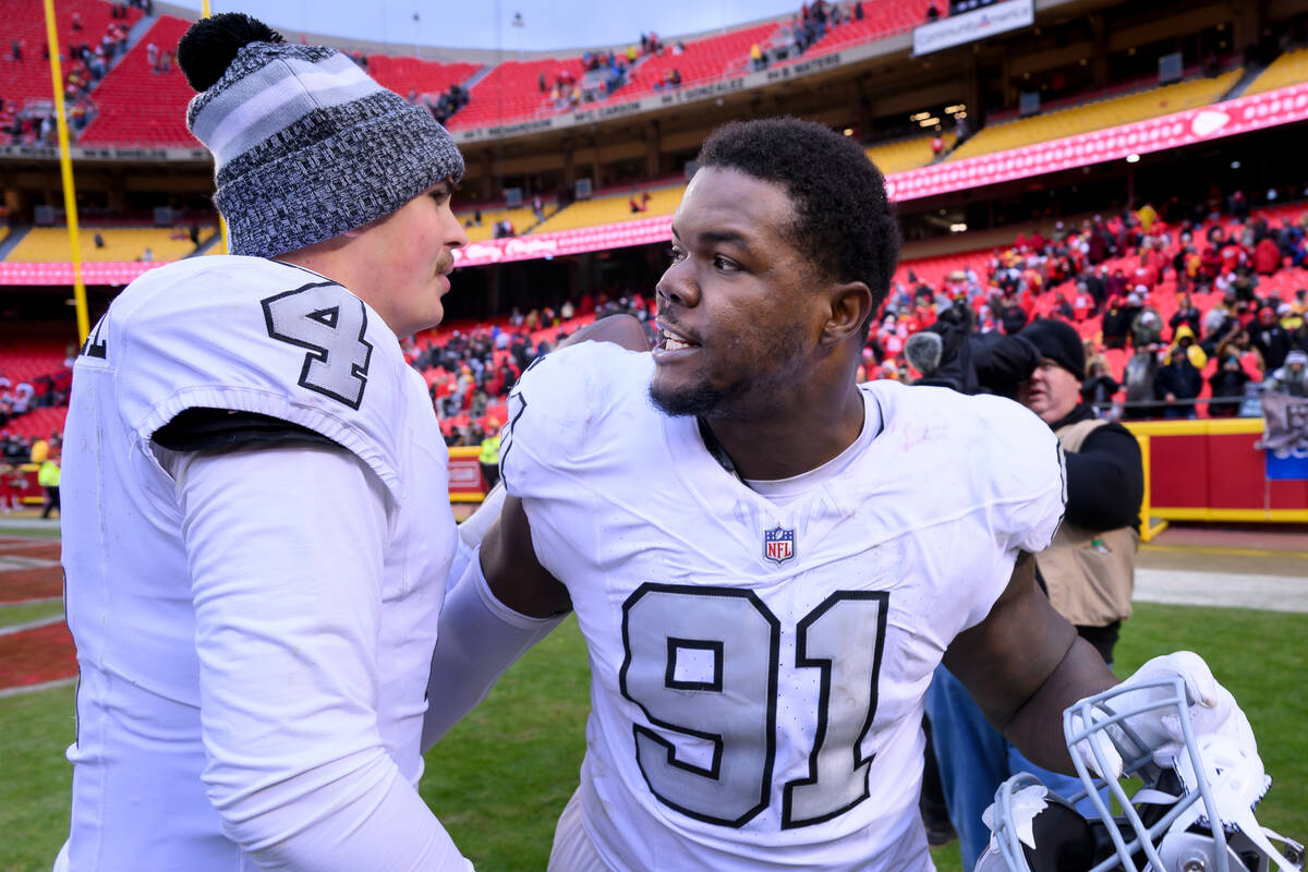 Las Vegas Raiders defensive tackle Bilal Nichols (91) and Raiders quarterback Aidan O'Connell, ...