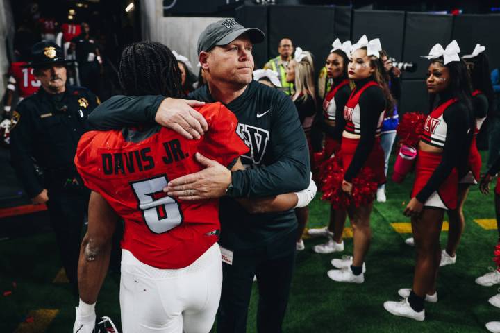 UNLV head coach Barry Odom hugs UNLV running back Vincent Davis Jr. after losing the Mountain W ...