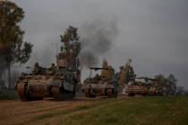 A convoy of Israeli army armoured personnel carriers (APC) moves near the Israeli-Gaza border, ...