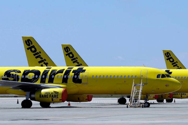 A line of Spirit Airlines jets sit on the tarmac at Orlando International Airport on May 20, 20 ...