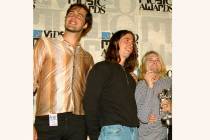 Nirvana band members Krist Novoselic, from left, Dave Grohl and Kurt Cobain pose after receivin ...