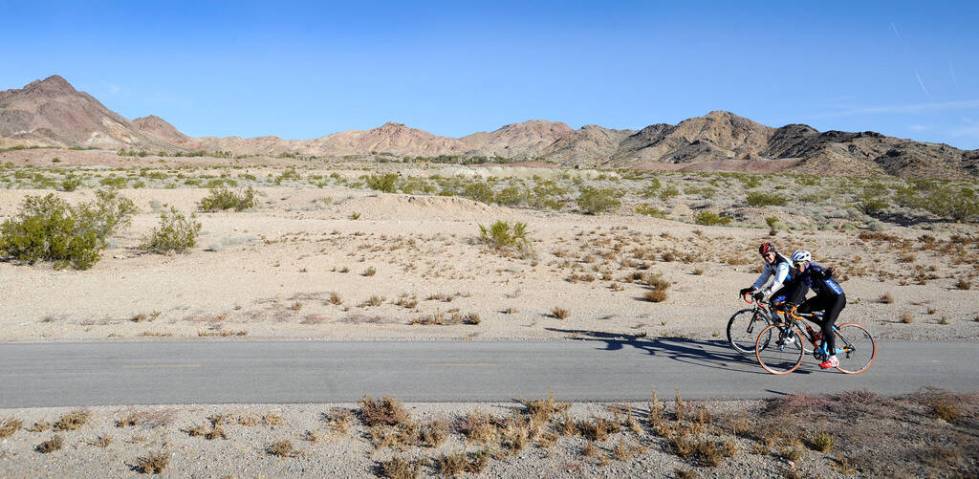 Jim Twomey, left and Vic Valenzuela bike along the River Mountains Trail near Boulder City on ...