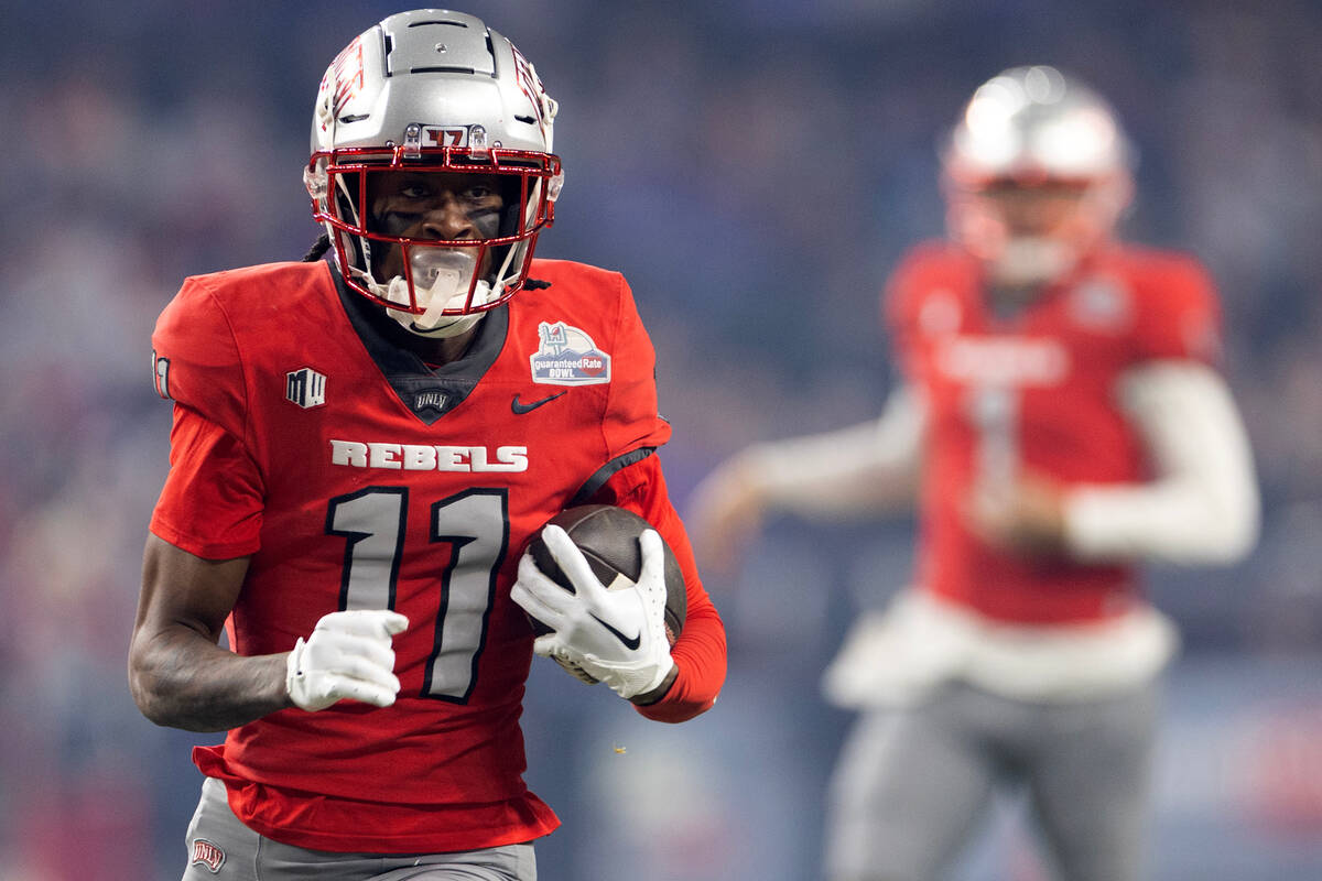 UNLV Rebels wide receiver Ricky White (11) runs the ball during the first half of the Guarantee ...