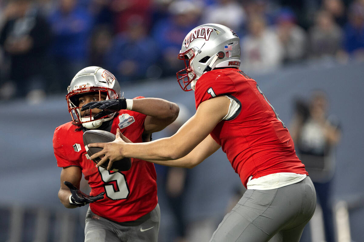 UNLV Rebels quarterback Jayden Maiava (1) hands the ball off to running back Vincent Davis Jr. ...