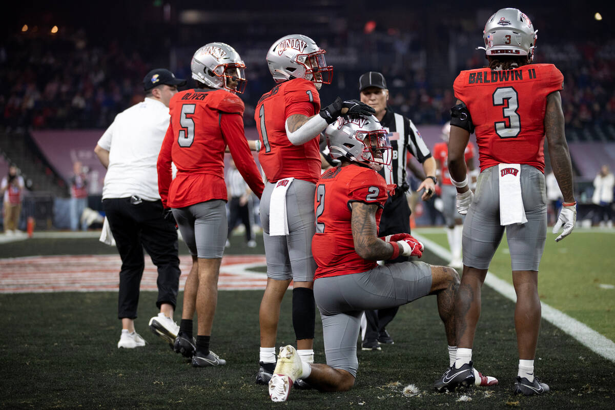 UNLV Rebels defensive back Jerrae Williams (1) comforts defensive back Jaxen Turner (2) after h ...