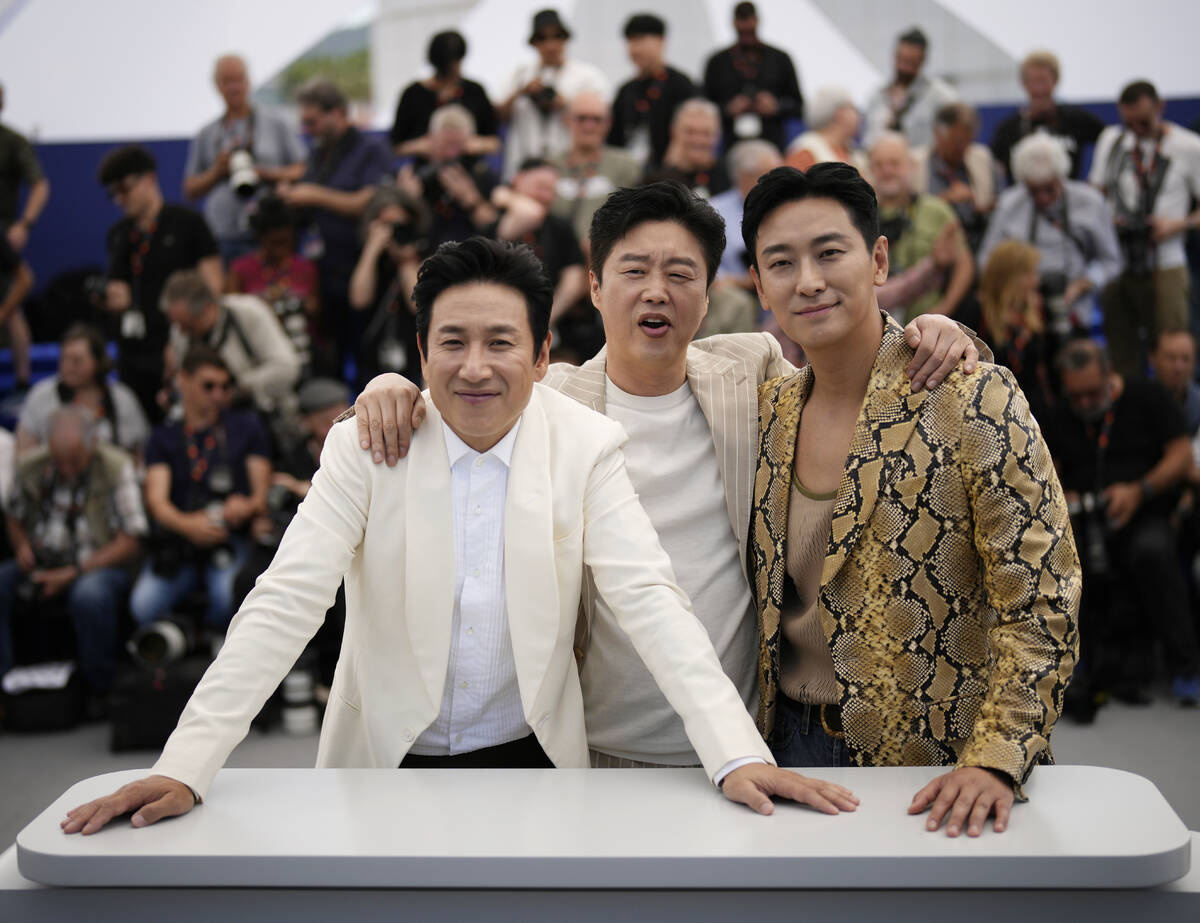 Lee Sun-kyun, from left, Kim Hee-won and Ju Ji-hoon poses for photographers at the photo call f ...