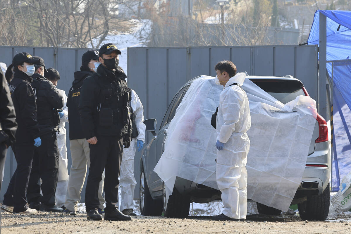 Members of the Korea Crime Scene Investigation team investigate the scene where South Korean ac ...