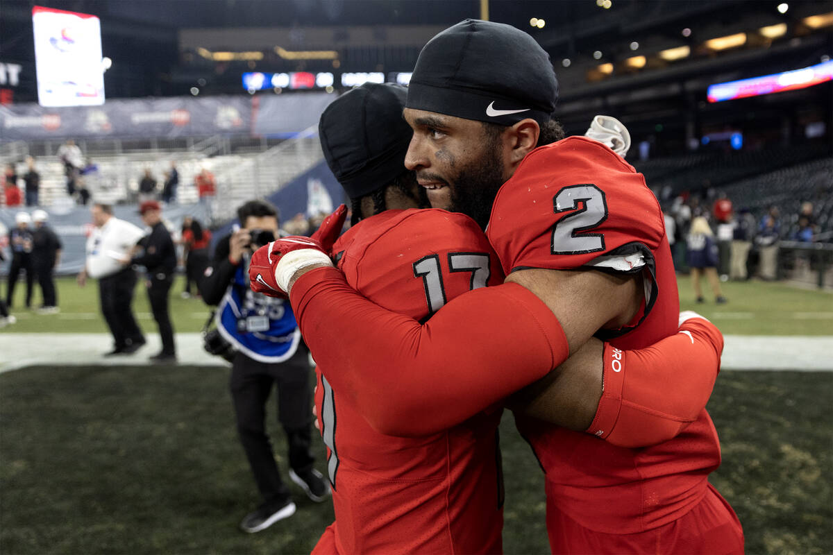 UNLV Rebels defensive back Kris Williams (17) and defensive back Jaxen Turner (2) embrace after ...