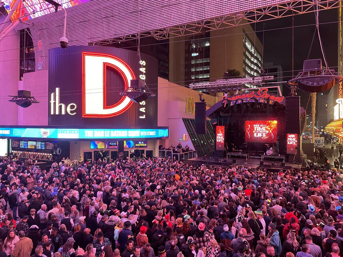 A large crowd is gathered at the Third Street Stage at the Fremont Street Experience just a few ...