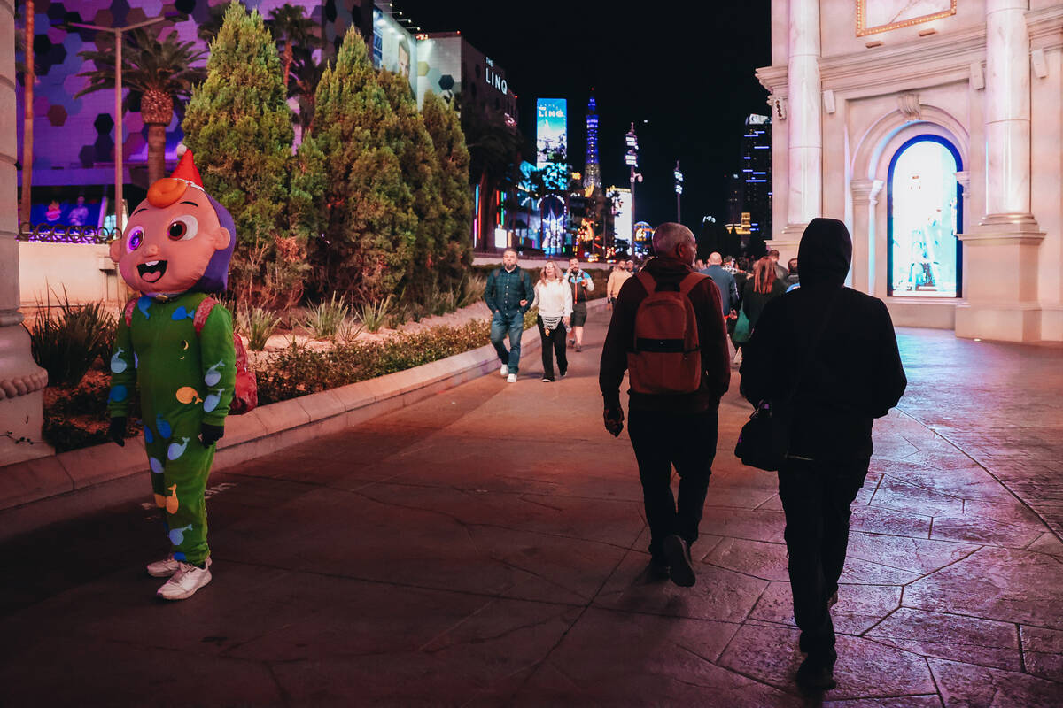 A person dressed like a baby walks the Strip on Sunday, Dec. 31, 2023, in Las Vegas. (Madeline ...