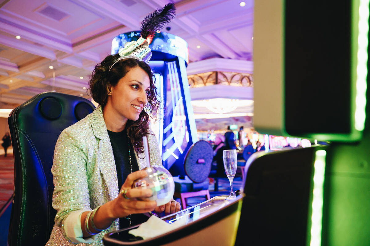 Shereen Hamed sits at a gambling machine inside of the Bellagio on Sunday, Dec. 31, 2023, in La ...