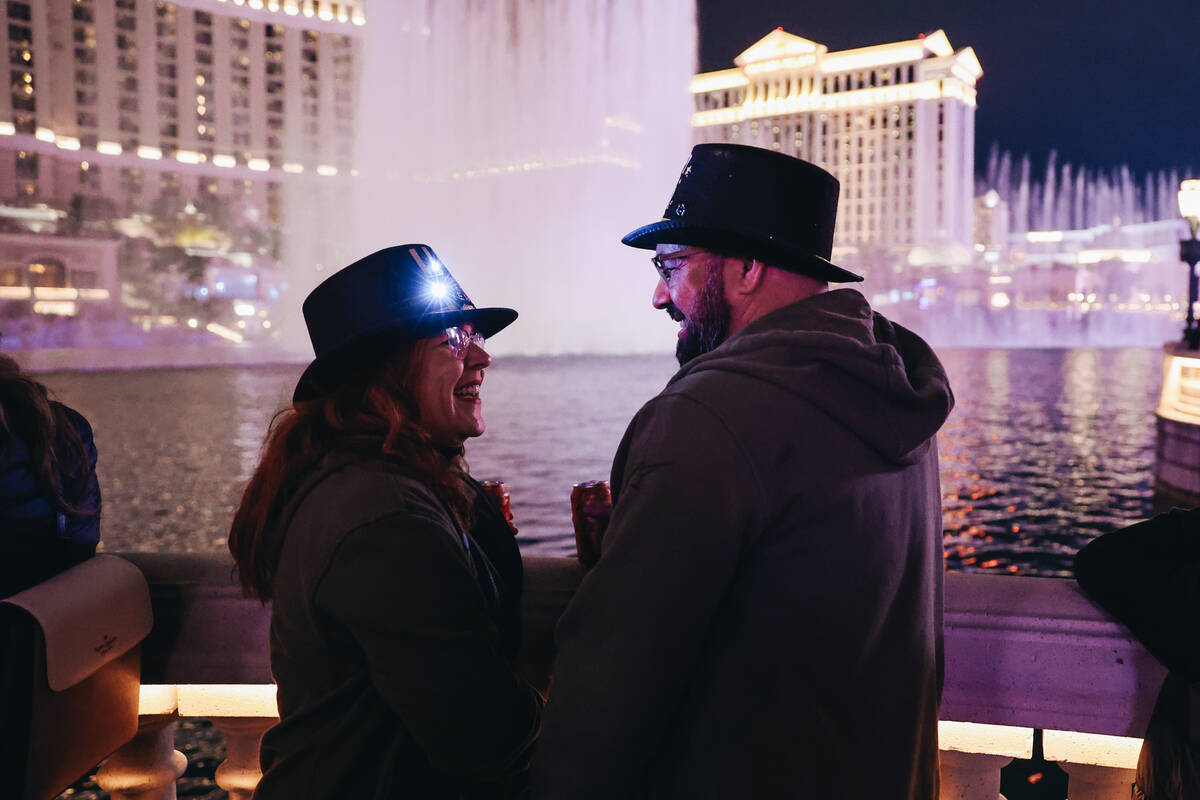 Maria Ferrera, left, and Frank Suarez side at each other as the Fountains of Bellagio go off be ...