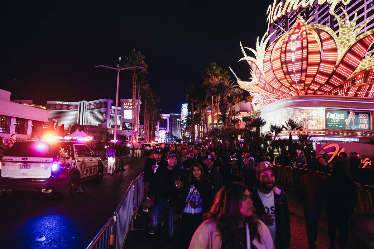 People walk throughout the streets on the Strip after they were closed off for New Year’ ...
