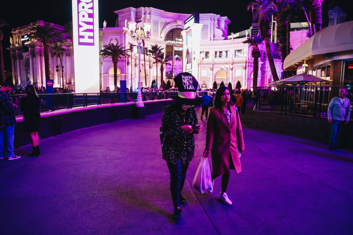 New Year revelers walk the Strip on Sunday, Dec. 31, 2023, in Las Vegas. (Madeline Carter/Las V ...