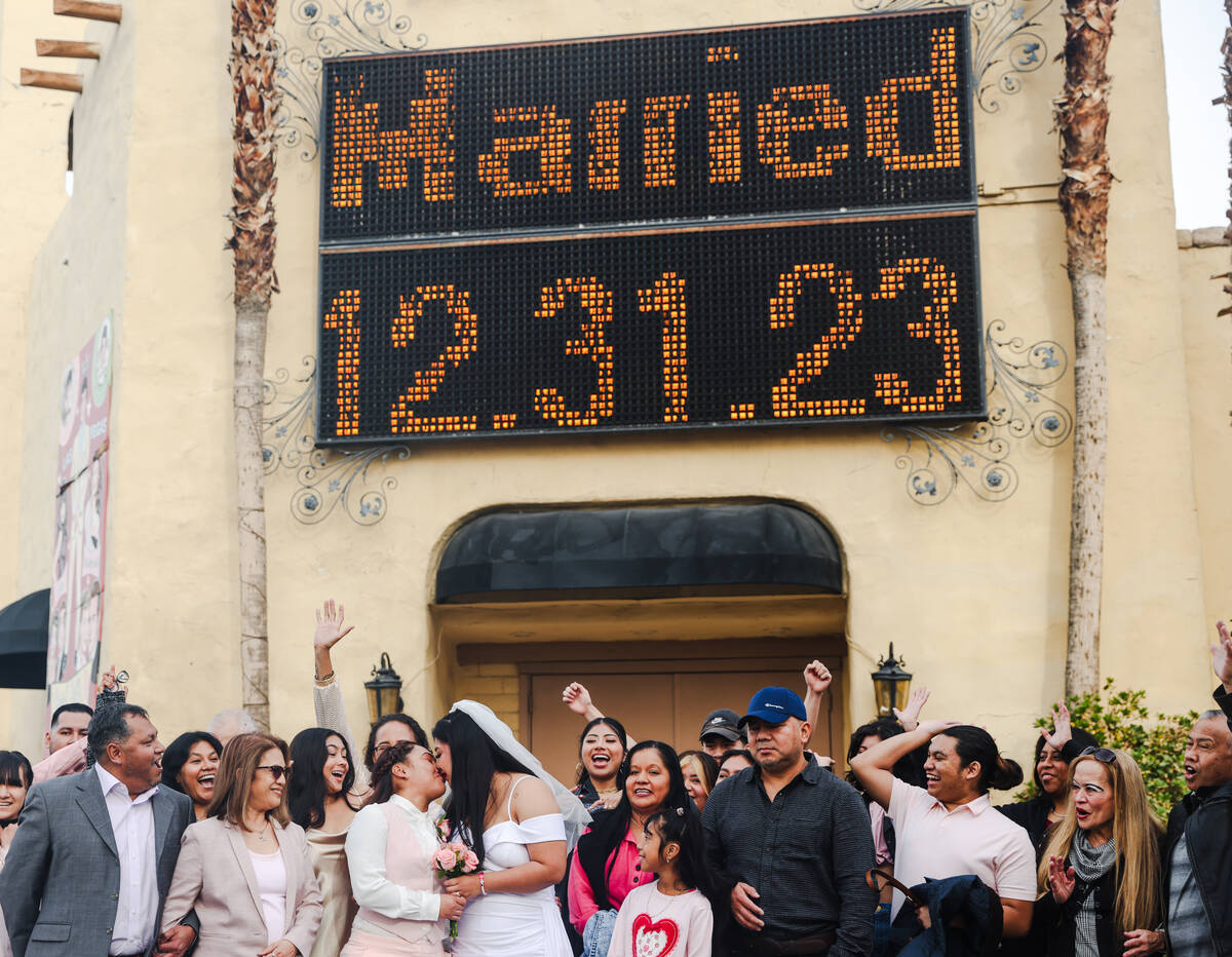 Anamarie Popoca, left, and Michelle Antonio, right, kiss after their wedding with their friends ...