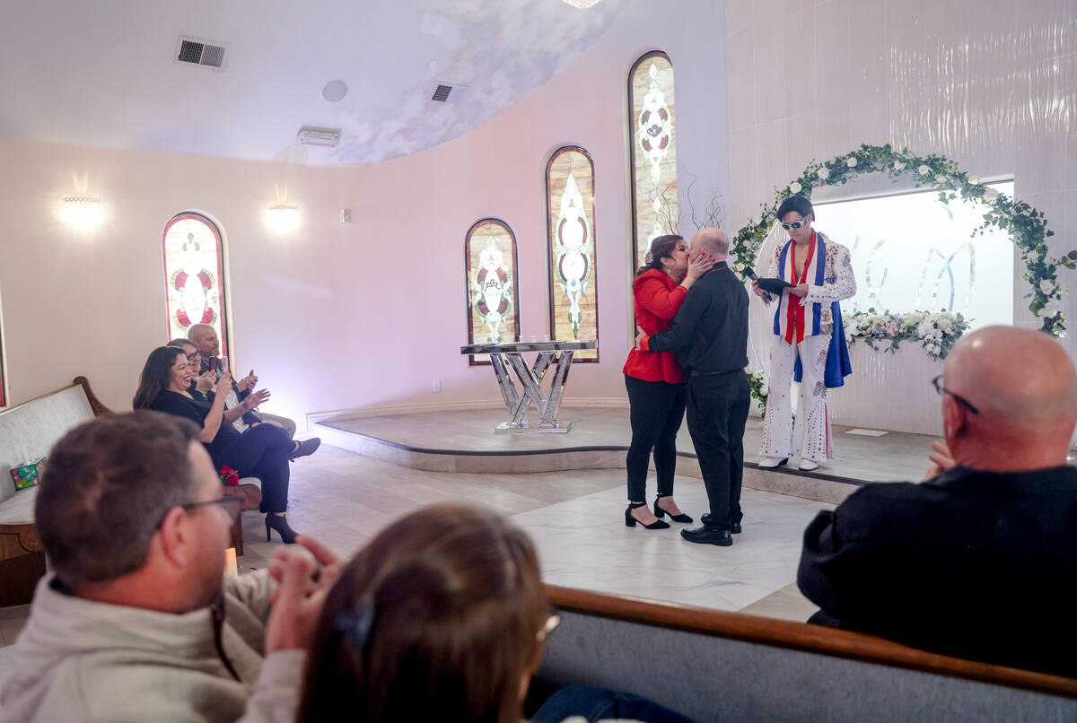 Amanda McIntire kisses Jeff McIntire at their wedding officiated by Elvis impersonator Ron Deca ...