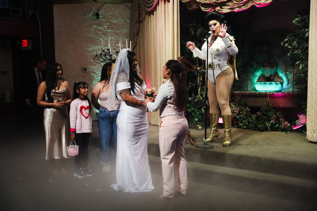 Martina “Sh-Elvis” Brookshire officiates the wedding of Michelle Antonio, left, a ...